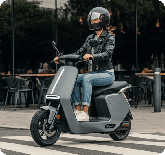 Person in orange jacket on scooter