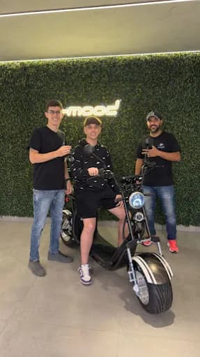 Person on scooter near cafe