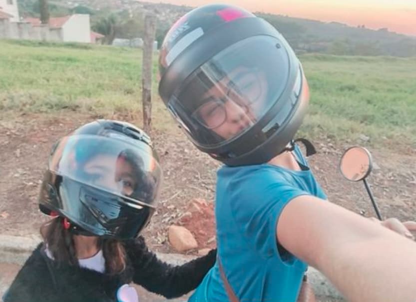 Person on scooter near cafe