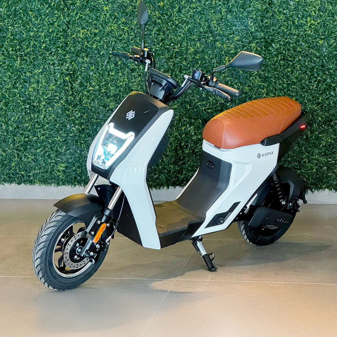 Person on scooter near cafe