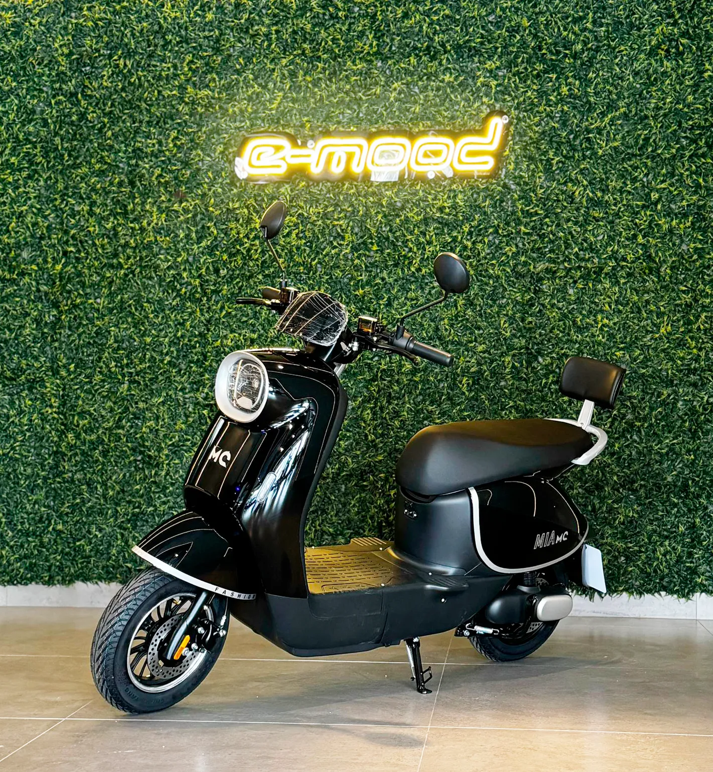 Person on scooter near cafe