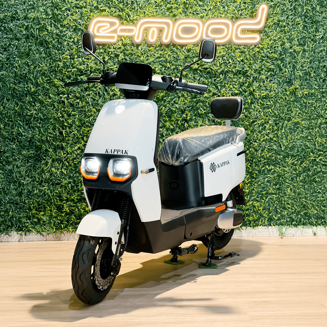 Person on scooter near cafe