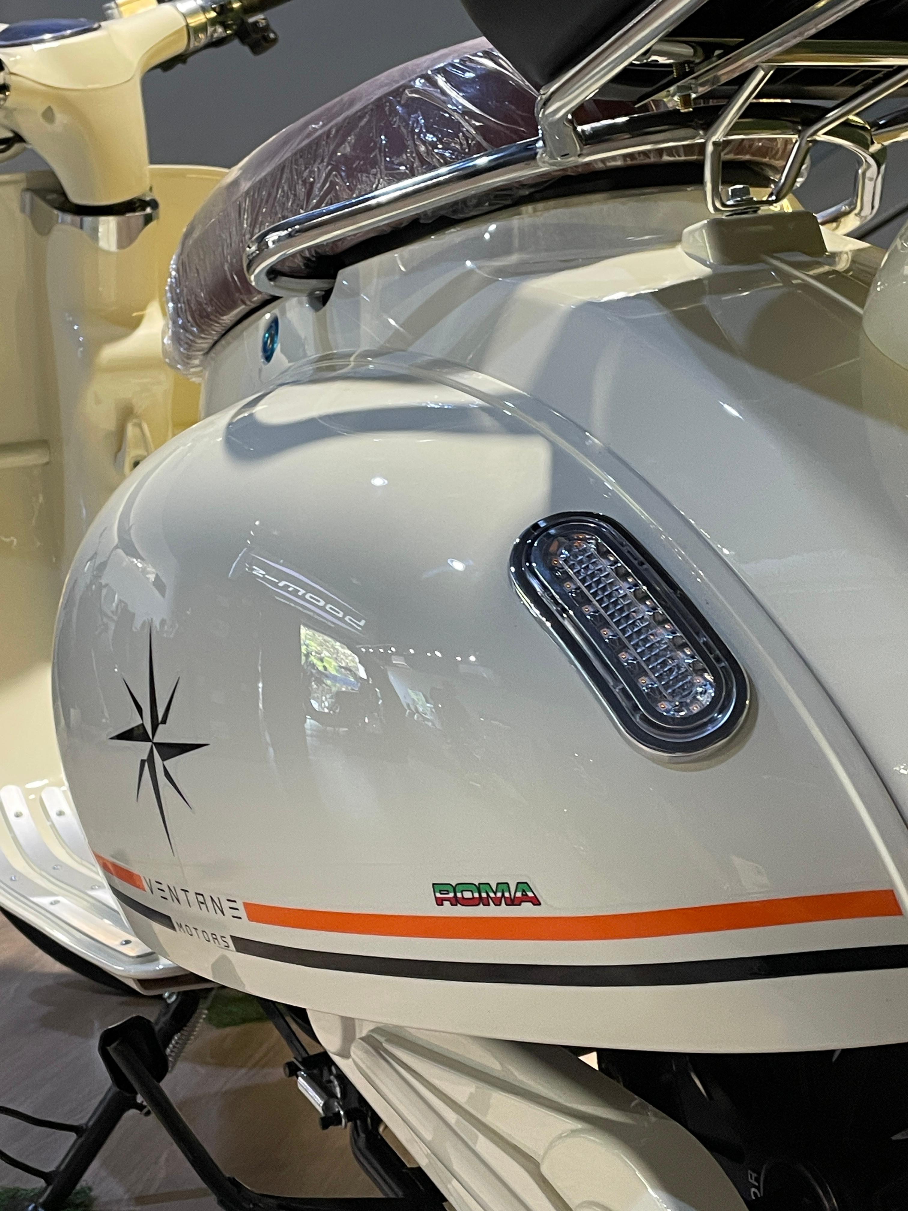 Person on scooter near cafe