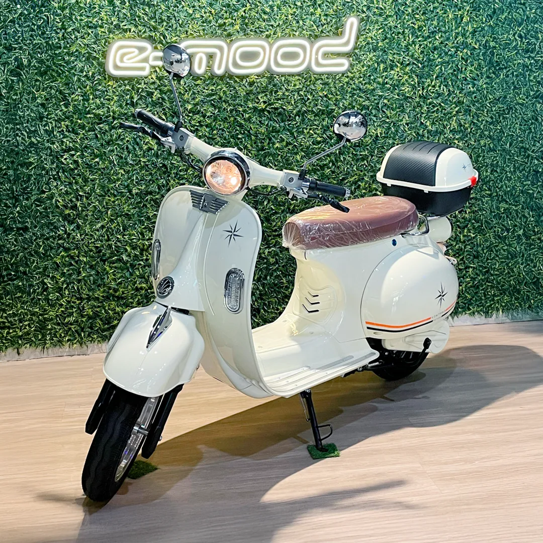 Person on scooter near cafe