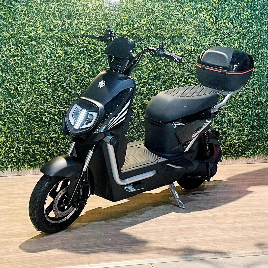 Person on scooter near cafe