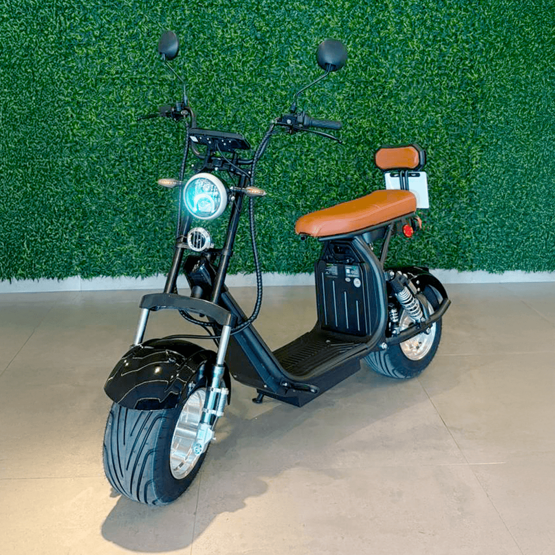 Person on scooter near cafe