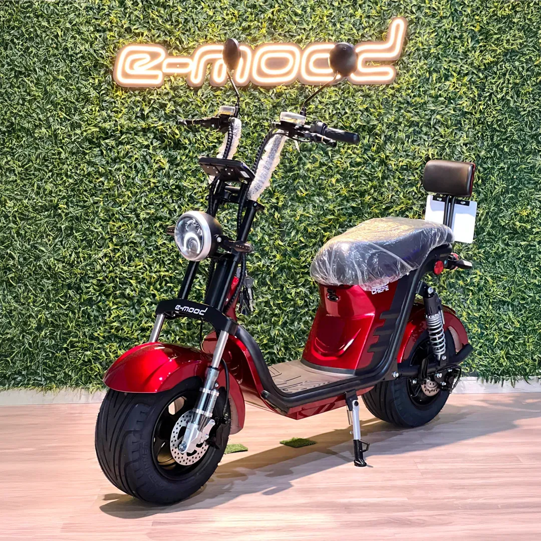 Person on scooter near cafe